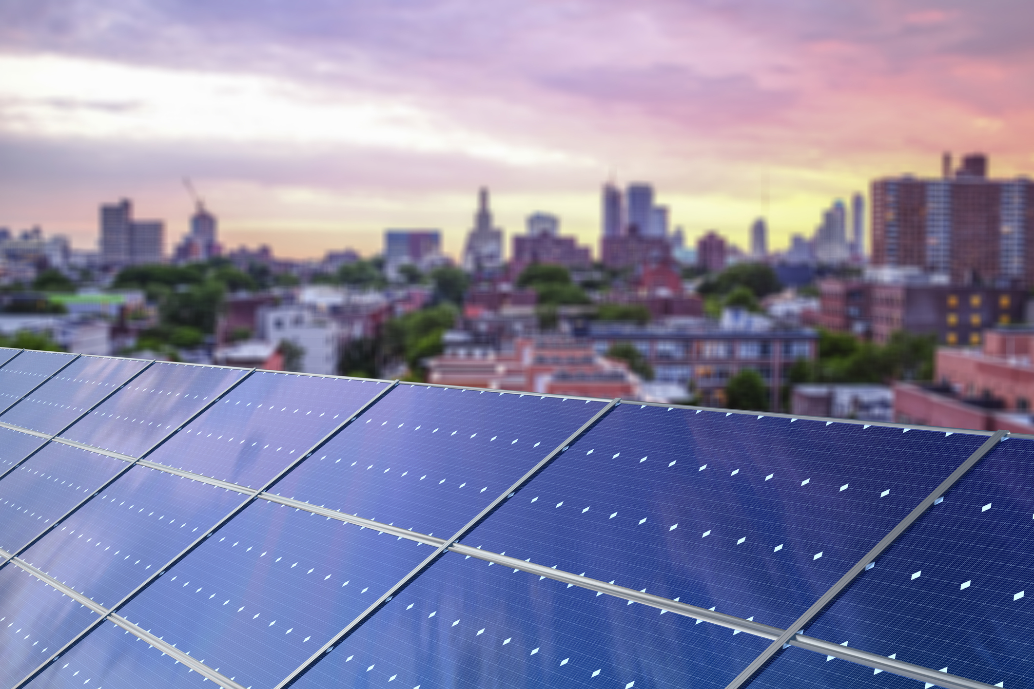 Solar panels in front of a city skyline