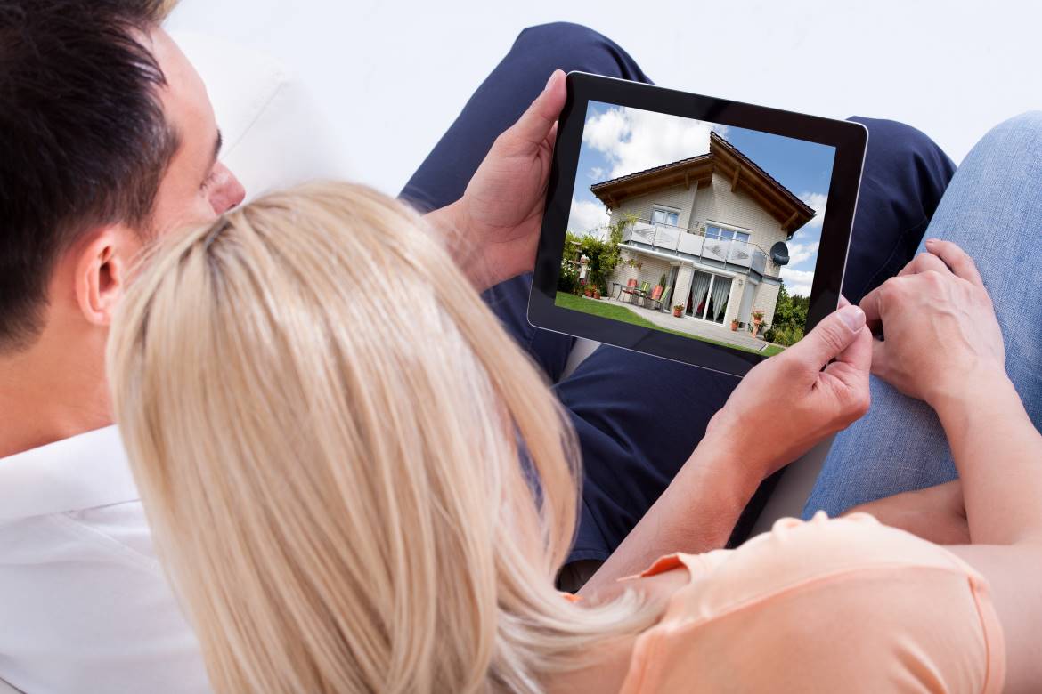Couple looking at house on iPad