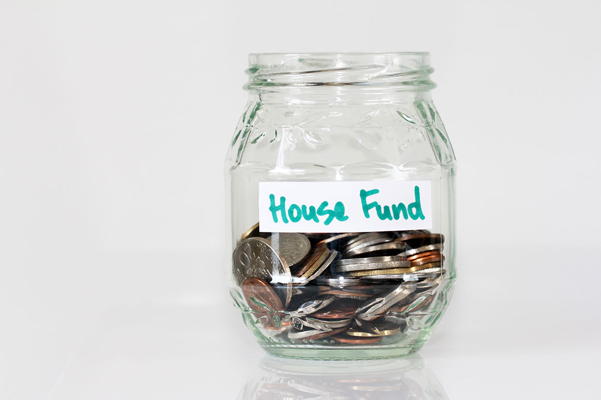 House fund jar with coins inside