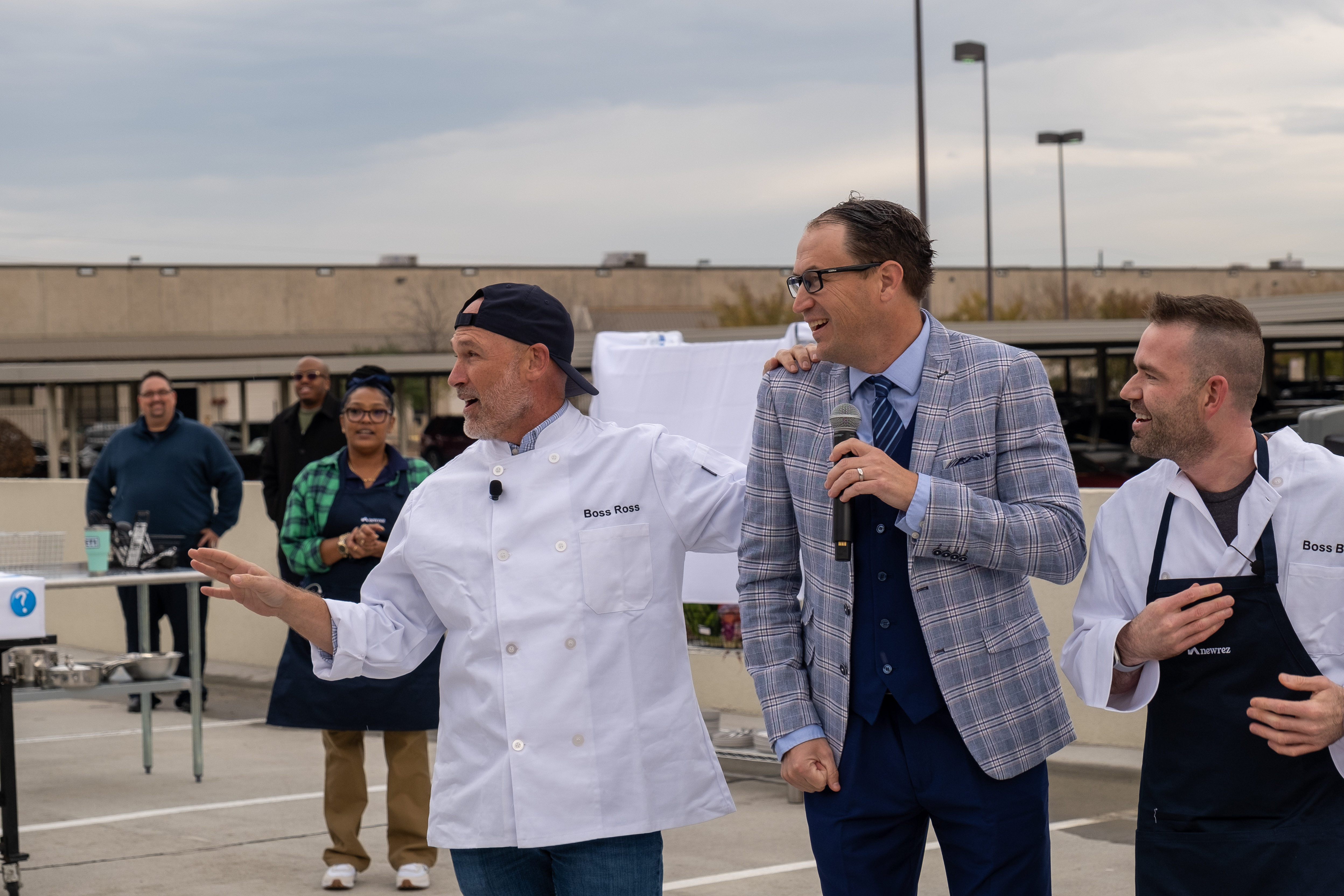 Three men talking into a microphone