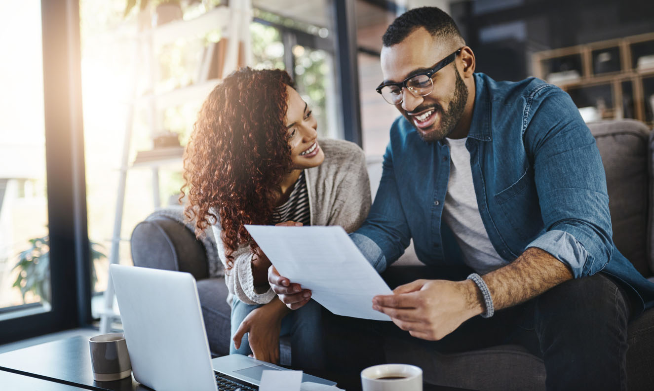 Couple looking at document and smiling