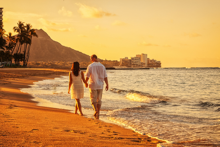 Couple walking on beach in Honolulu