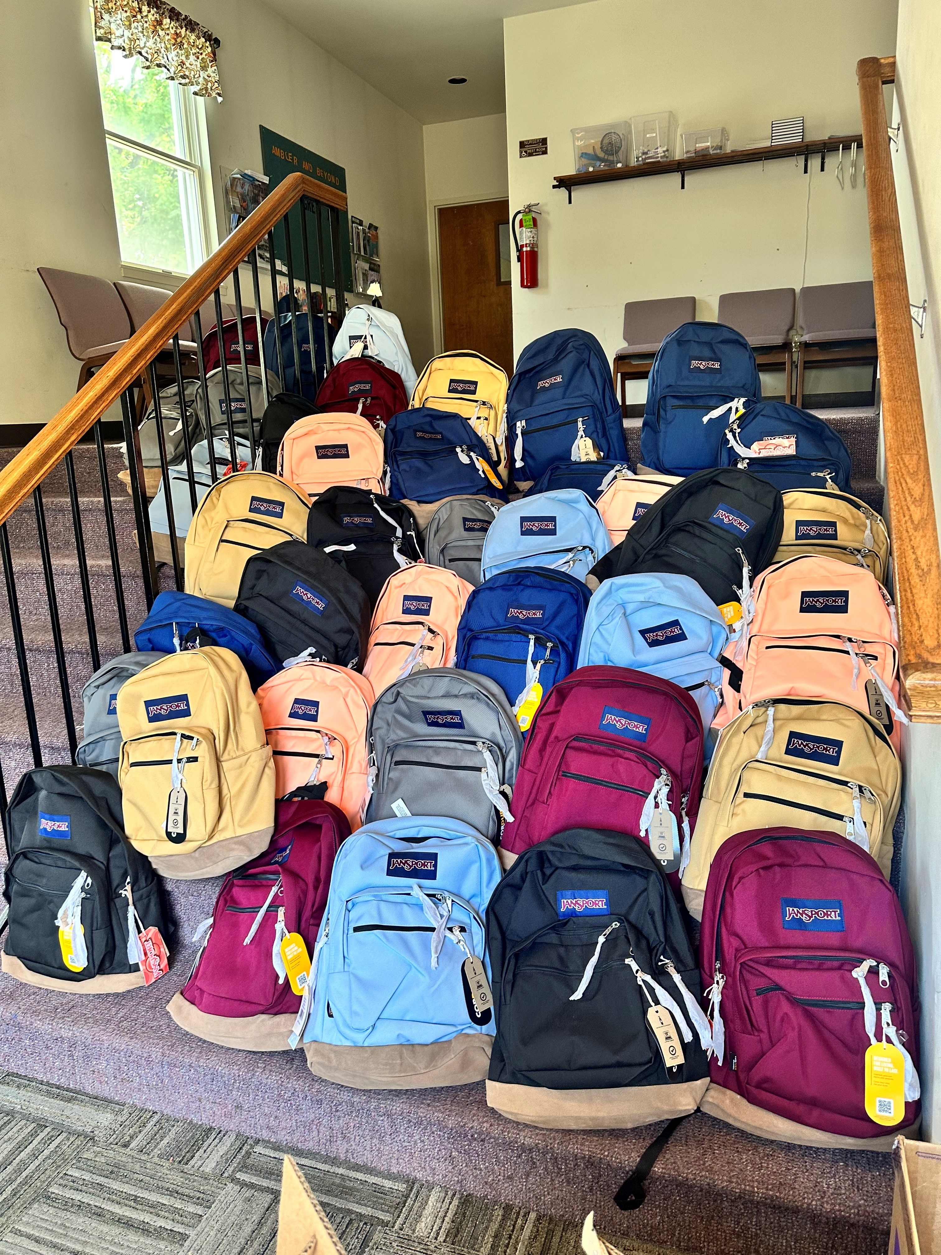 A staircase with stacks of backpacks