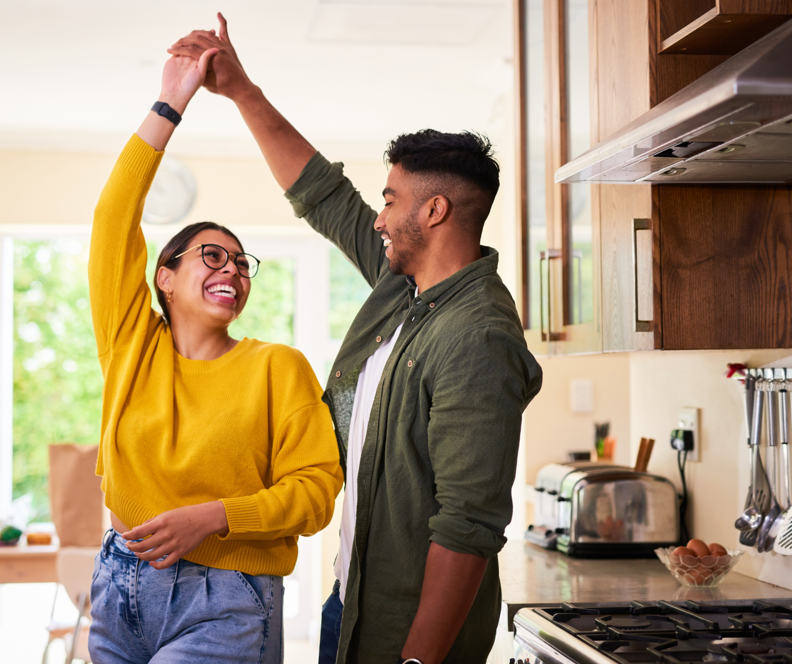 a hispanic couple dancing in the kitchen